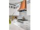 Close up of copper range hood over stainless steel stove in a modern kitchen with white cabinets at 18 Logan St, Charleston, SC 29401