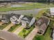 Aerial view of the house showcasing its well-manicured lawn, landscaping, and neighborhood setting near the water at 213 Palmetto Walk Dr, Summerville, SC 29486