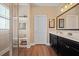 Bright bathroom featuring a double vanity with dark cabinets and a glass-enclosed shower with built-in shelving at 213 Palmetto Walk Dr, Summerville, SC 29486