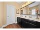 Bathroom with a large mirror above a double vanity with dark cabinets, offering ample counter space at 213 Palmetto Walk Dr, Summerville, SC 29486