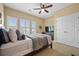 Comfortable bedroom with carpet floors, three windows and a ceiling fan at 213 Palmetto Walk Dr, Summerville, SC 29486