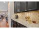 Chic butler's pantry featuring granite countertops and dark wood cabinets at 213 Palmetto Walk Dr, Summerville, SC 29486