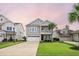 Charming two-story home with a well-manicured lawn and an attached two-car garage at 213 Palmetto Walk Dr, Summerville, SC 29486