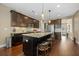 This stylish kitchen features dark cabinetry, granite counters, stainless appliances, and seating at the island at 213 Palmetto Walk Dr, Summerville, SC 29486