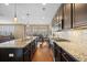Well-lit kitchen with stainless steel appliances, granite countertops, tile backsplash, and center island with seating at 213 Palmetto Walk Dr, Summerville, SC 29486