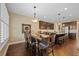 Open concept kitchen and dining area with dark wood cabinets, stainless appliances, and hardwood floors at 213 Palmetto Walk Dr, Summerville, SC 29486