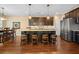Modern kitchen boasts dark cabinets, granite countertops, stainless steel appliances, and pendant lighting at 213 Palmetto Walk Dr, Summerville, SC 29486