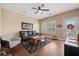 Cozy living room with comfortable seating, ceiling fan, and natural light from the windows and door at 213 Palmetto Walk Dr, Summerville, SC 29486