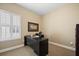 Bright office space with a large window, a modern desk, and comfortable seating at 213 Palmetto Walk Dr, Summerville, SC 29486