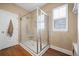 Tiled walk-in shower features glass enclosure and bright lighting, accented by a window at 213 Palmetto Walk Dr, Summerville, SC 29486