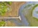 Overhead view of a long wooden boardwalk extending into a marshy waterway from a community at 2176 Andover Way, Mount Pleasant, SC 29466