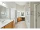 Spacious bathroom featuring dual sinks, wooden cabinets, vanity area with seat, a soaking tub, and tiled floors at 2176 Andover Way, Mount Pleasant, SC 29466
