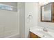 Well-lit full bathroom with tile surround, decorative mirror, and a white vanity at 2176 Andover Way, Mount Pleasant, SC 29466