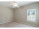 Neutral bedroom with plush carpet, ceiling fan, and natural light from the window with white shutters at 2176 Andover Way, Mount Pleasant, SC 29466