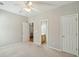 Bright bedroom featuring neutral walls, carpet, ceiling fan, with ensuite bathroom and hall closet at 2176 Andover Way, Mount Pleasant, SC 29466