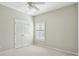 Neutral bedroom featuring carpet, ceiling fan, window with blinds, and a double-door closet at 2176 Andover Way, Mount Pleasant, SC 29466