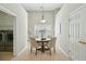 Bright breakfast nook with hardwood table set for four, tile floors, and lots of natural light at 2176 Andover Way, Mount Pleasant, SC 29466