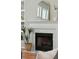 Elegant fireplace with marble surround, decorative mantel, and arched mirror adds charm to the living space at 2176 Andover Way, Mount Pleasant, SC 29466