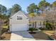 Charming single-Gathering home featuring an attached garage, well-manicured lawn, and inviting front porch at 2176 Andover Way, Mount Pleasant, SC 29466