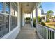 Inviting front porch offers a relaxing outdoor space with white railings and a ceiling fan at 2176 Andover Way, Mount Pleasant, SC 29466