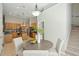 Open kitchen with stainless appliances, wood cabinets and island with pendant lighting and seating at 2176 Andover Way, Mount Pleasant, SC 29466
