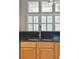 Kitchen sink with granite countertops and wooden cabinets with a view of a bright living room at 2176 Andover Way, Mount Pleasant, SC 29466