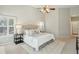 Bright main bedroom featuring high ceilings, ceiling fan, neutral decor, and a plush bed with decorative pillows at 2176 Andover Way, Mount Pleasant, SC 29466