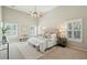 Main bedroom with high ceiling, ceiling fan, neutral decor, and three shuttered windows at 2176 Andover Way, Mount Pleasant, SC 29466
