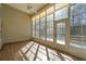 Well-lit sunroom with many windows, tiled flooring, and a ceiling fan to circulate air, and a door to exit at 2176 Andover Way, Mount Pleasant, SC 29466