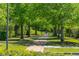 Charming brick walking path lined with lush trees and greenery offering a peaceful retreat for residents at 2176 Andover Way, Mount Pleasant, SC 29466