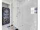 This is a modern bathroom with a glass-enclosed shower and a stacked washer and dryer at 225 Bird Song Path, Summerville, SC 29485