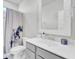 Bright bathroom features a gray vanity and framed mirror, with a decorative floral shower curtain at 225 Bird Song Path, Summerville, SC 29485