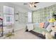 Bright bedroom featuring a window desk, natural decor and leafy accent wall at 225 Bird Song Path, Summerville, SC 29485