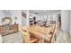 Open dining area with a rustic wooden table, seamlessly connected to the living room and kitchen at 225 Bird Song Path, Summerville, SC 29485