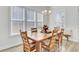 Bright dining room with a large wooden table, perfect for Gathering gatherings and entertaining guests at 225 Bird Song Path, Summerville, SC 29485