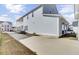 Long driveway leading to a modern home, with a side view showcasing its architecture at 225 Bird Song Path, Summerville, SC 29485