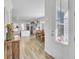Welcoming entryway featuring wood floors, leading to a bright, open-concept dining and kitchen area at 225 Bird Song Path, Summerville, SC 29485