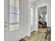 Bright entryway featuring hardwood floors, a front door with glass panels and a view of the living room at 225 Bird Song Path, Summerville, SC 29485