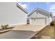 A detached two-car garage is next to the house with a wide driveway and newly landscaped planting bed at 225 Bird Song Path, Summerville, SC 29485