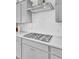 Modern kitchen showcasing a stainless steel stove top and hood with white subway tile backsplash at 225 Bird Song Path, Summerville, SC 29485
