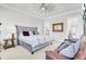This is a spacious main bedroom with a tufted headboard and a sitting area at 225 Bird Song Path, Summerville, SC 29485