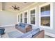 Cozy covered patio with outdoor seating, ceiling fan, and neutral tones to enjoy outdoor living at 225 Bird Song Path, Summerville, SC 29485