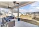 Inviting patio showcases outdoor seating, ceiling fans, with a view of the expansive backyard at 225 Bird Song Path, Summerville, SC 29485