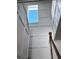 Bright staircase features white paneling and a high window that floods the space with natural light at 225 Bird Song Path, Summerville, SC 29485