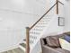 This is a staircase with white trim, wood railing, and a shiplap accent wall at 225 Bird Song Path, Summerville, SC 29485