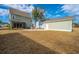 Backyard showcasing a patio, screened porch, detached garage, and landscaping at 2270 Kemmerlin St, Johns Island, SC 29455
