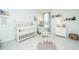 Cozy Bedroom featuring a crib, soft colors, and a comfortable armchair at 2270 Kemmerlin St, Johns Island, SC 29455