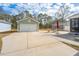Long driveway leading to detached garages with an umbrella and chairs beside the garage at 2270 Kemmerlin St, Johns Island, SC 29455