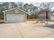 Wide driveway leading to the garage with an umbrella and chairs to the side at 2270 Kemmerlin St, Johns Island, SC 29455