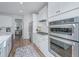 Modern kitchen featuring stainless steel appliances, white cabinetry, and a stylish backsplash at 2270 Kemmerlin St, Johns Island, SC 29455
